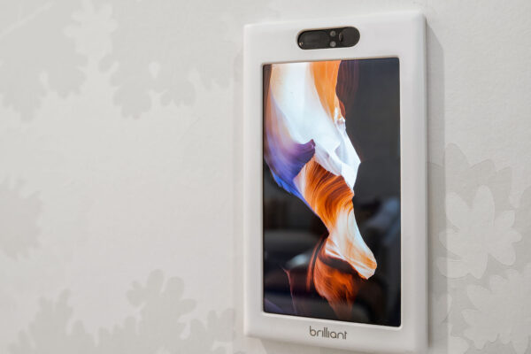 Image of a Brilliant Smart Home hub screen on a white wall. 