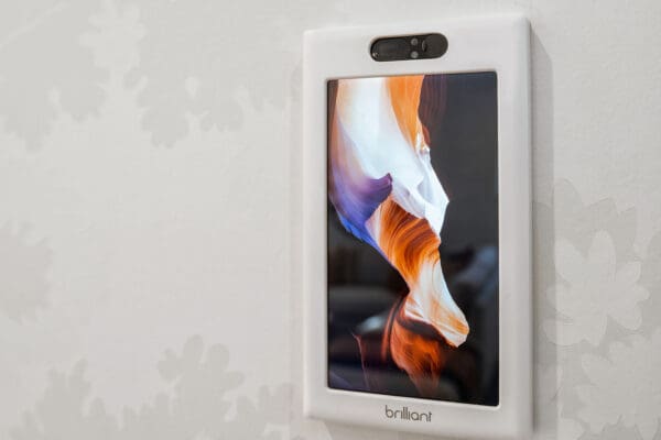 Image of a Brilliant Smart Home hub screen on a white wall.