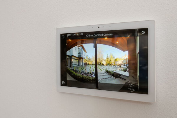 Image of Chime Doorbell Camera on a white wall. The camera displays the stoop of the front door.